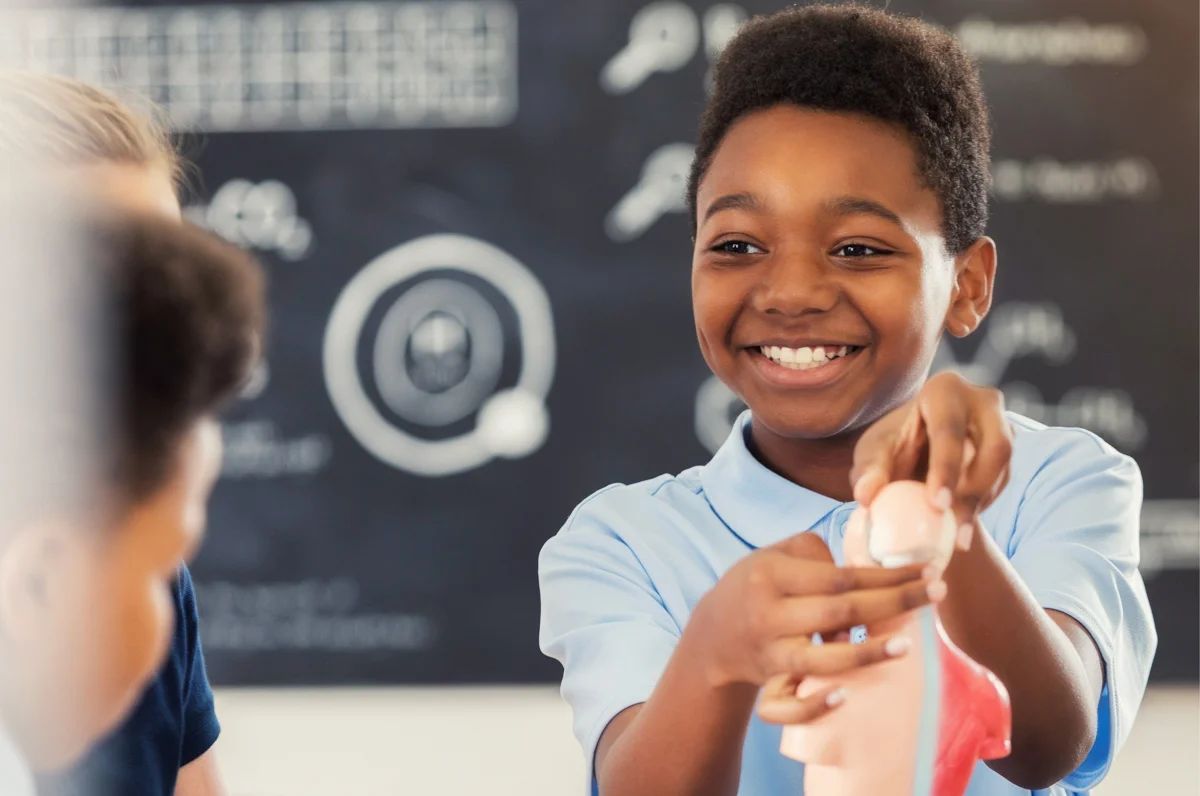 middle school student showcasing his work