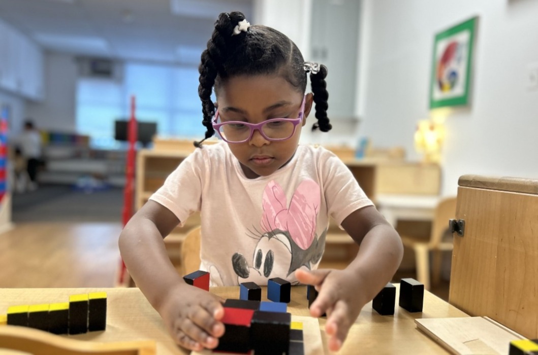 students spelling with letter blocks